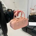 Modern pink glossy PVC jelly pillow bag featuring a stylish handheld design and chic finish - Pink