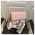 Detail van roze en witte crossbodytas met geborduurde brede riem en gouden hardware - Roze