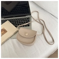 Close-up of beige mini crossbody bag in pebble grain leather on a white textured background - Dark Khaki
