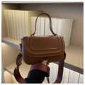 Detailed view of the brown leather crossbody bag with elegant gold hardware and strap - Brown