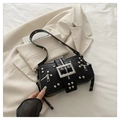 Punk style black leather crossbody bag featuring silver studs and large metal buckle - Black