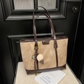 Detail of a large khaki tote bag with dark brown leather handles and ice cream charm - Khaki (No Pendant)