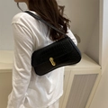 Elegant black baguette underarm bag featuring crocodile pattern leather and gold buckle - Black