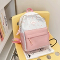Pink and white school backpack with star patterns and cloud logo on a yellow chair - Pink