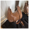 Detailed macro view of the smooth brown PU leather texture and silver hardware of the hobo bag - Half Moon Hobo Bag / Brown