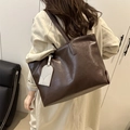 Brown oil wax leather tote bag with large capacity shown in a cozy indoor scene - Brown