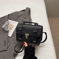 British style vintage black satchel bag with silver buckles on white sheet background - Black