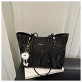 Detail of black wrinkled texture tote bag with silver logo and white plush charm - Black With Pendant