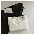Detail view of cream tote bag with wrinkled texture, black rope strap and metal logo - White (Without Charm)