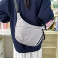 Light grey nylon crescent crossbody bag with adjustable wide strap and zip closure - Gray