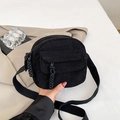 Black corduroy crossbody bag with adjustable nylon strap and front flap pocket detail - Black