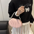 Pink shell-shaped handbag featuring a round pearl handle and slim crossbody strap - Pink