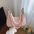 Pale pink half-moon shoulder bag with elegant pearl chain and chic gold hardware - Pink