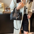 Fashionable black woven handbag for women with adjustable strap and silver buckle detail - Black