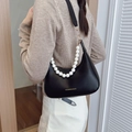 Black leather hobo bag with elegant pearl chain strap and gold hardware accents - Black