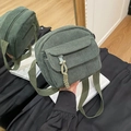 Green corduroy crossbody bag featuring a front zipper pocket and woven rope puller - Green