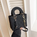 Elegant black quilted handbag with gold hardware and top handle in a sleek finish - With Pendant / Black