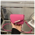 Detail of fuchsia mini crossbody bag with gold metal bar and asymmetric flap design - Rose Pink