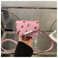 Detail of pink cherry print mini crossbody bag with silver metal bar and PU leather texture - Cherry Pink