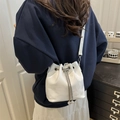 White oil-wax leather bucket bag with silver chain and pearl drawstring charms - White