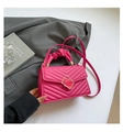 Detail of fuchsia pleated handle bag with chevron quilting and golden buckle - Rose Red