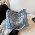 Light blue quilted bucket bag with star diamond accent and metal chain strap - Blue