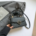 Elegant black quilted leather handbag with gold geometric buckle and cloud handle for women - Black