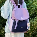 Outdoor view of a two-tone hiking backpack featuring purple and navy blue waterproof fabric - Large Purple With Brown Cloud Tag No Charm