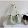 Detail showing woven texture and silver buckle of the light green faux leather tote bag - Green