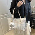 White quilted tote bag with wave embroidery and plush cloud pendant on a model - White With Cloud Pendant