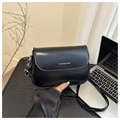 Detail of black glossy faux leather shoulder bag with FANYISSA & BAG logo and silver hardware - Black