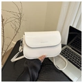 Detailed view of white minimalist square crossbody bag with brand logo and silver hardware - White