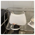Detail of white half-moon bag featuring a gold FASHION logo and smooth leather texture - White