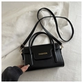 Detail of black leather square bag with gold FASHION text and elegant metal hardware - Black