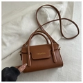 Top view of brown PU leather handbag with gold FASHION text and top handles - Tan
