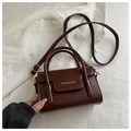 Detail of burgundy vintage square crossbody bag with gold FASHION text on soft fabric - Dark Brown