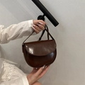 Dark brown glossy saddle bag with shoulder strap and sleek minimalist aesthetic - Brown