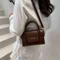 Vintage brown leather crossbody bag with gold fashion lettering and a top handle - Dark Brown