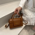Chic brown vintage crossbody handbag with fashion print and gold-tone buckle details - Tan