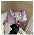 Détail d'un sac porté épaule lavande avec boucle papillon argentée et cuir mat - Violet