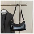 Detail of glossy black faux leather shoulder bag with gold zipper on a suit background - Glossy Black