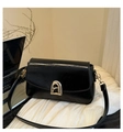 Detail of glossy black leather handbag with a gold A-shaped geometric lock buckle - Black