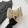 Chic cream-colored underarm bag featuring a metallic star buckle and textured PU leather - White