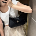 Minimalist black faux leather shoulder bag featuring a silver star buckle and slim strap - Black