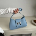 Light blue shoulder bag with silver bow buckle in a trendy faux leather finish - Blue