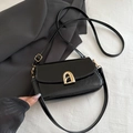 Minimalist black oil-wax leather crossbody bag featuring a golden arched metal buckle - Black