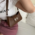 Brown leather baguette bag with a silver metallic bow and slim shoulder strap - Brown