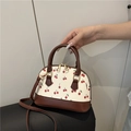 Minimalist cream shell bag with red cherry print and dark brown handles - Brown