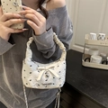 White cloud-texture handbag featuring black bow patterns and silver heart charm - White
