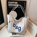 Weiße Canvas-Einkaufstasche mit blauem Bag-Aufdruck und bequemen Schultergurten - Weiß